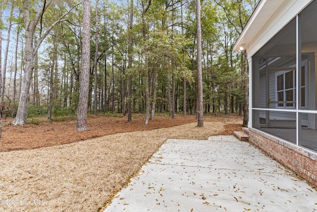 view of yard with a patio area and a sunroom