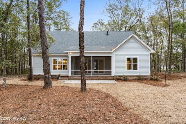 back of property featuring roof with shingles and a sunroom