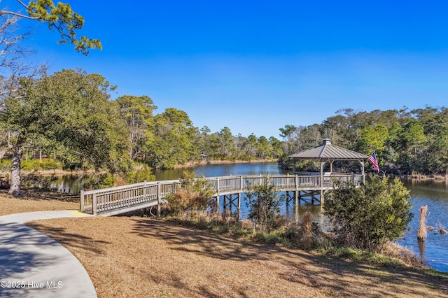 view of dock with a gazebo and a water view