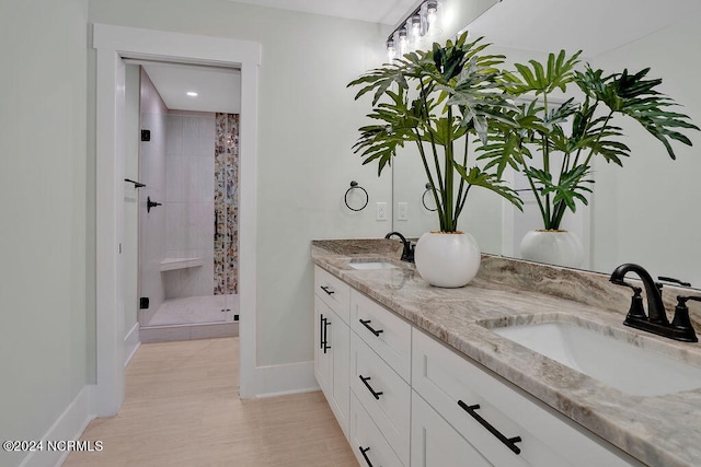 bathroom featuring vanity and an enclosed shower