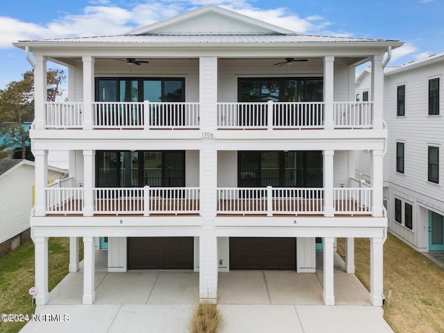 back of house featuring ceiling fan, a balcony, and a garage