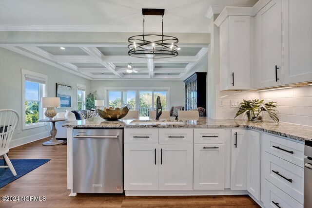 kitchen with tasteful backsplash, beamed ceiling, sink, white cabinets, and coffered ceiling