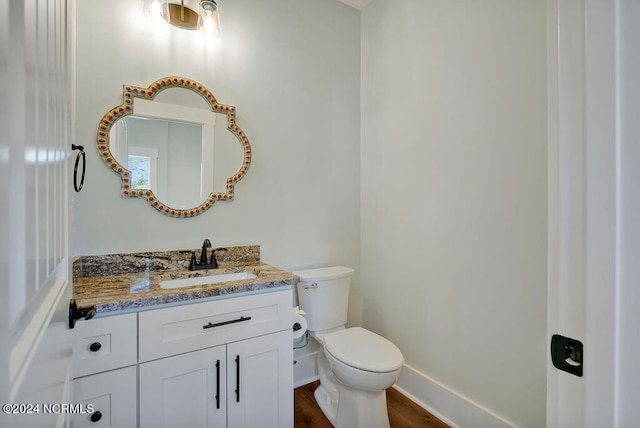 bathroom with vanity, hardwood / wood-style flooring, and toilet