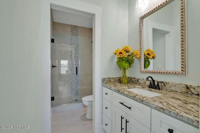 bathroom with toilet, vanity, tile patterned floors, and walk in shower