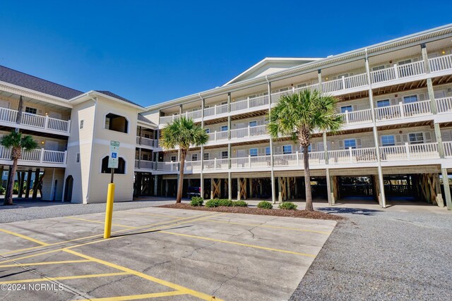 view of building exterior with uncovered parking