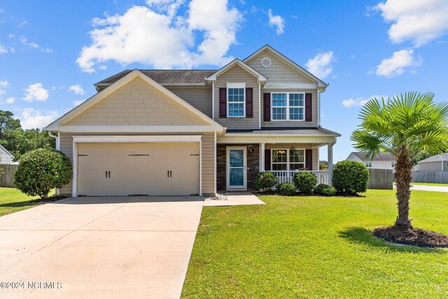 craftsman house with a garage, a porch, and a front yard