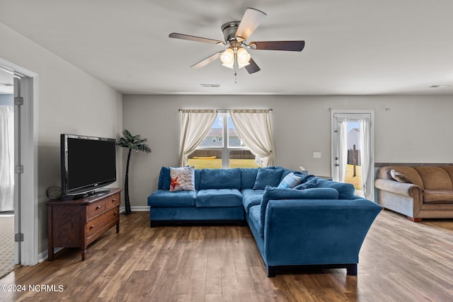 living room with wood-type flooring and ceiling fan