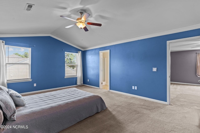 bedroom with carpet, vaulted ceiling, crown molding, and ceiling fan