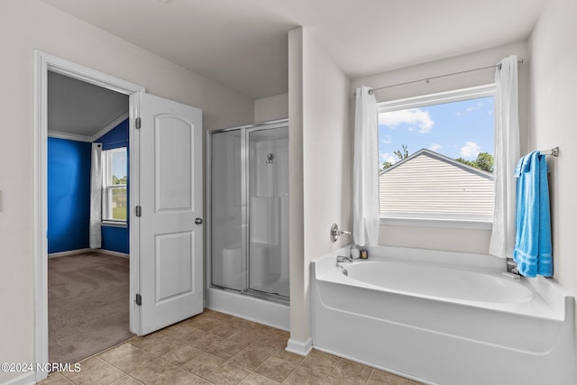 bathroom with a wealth of natural light, shower with separate bathtub, and tile patterned floors