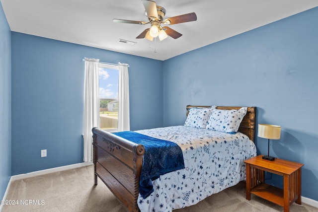 bedroom featuring light colored carpet and ceiling fan