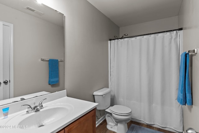 bathroom with vanity, wood-type flooring, and toilet