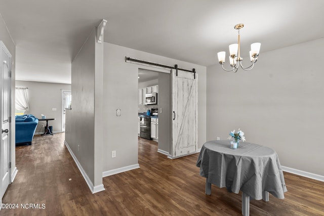 dining area with a chandelier, dark hardwood / wood-style flooring, and a barn door