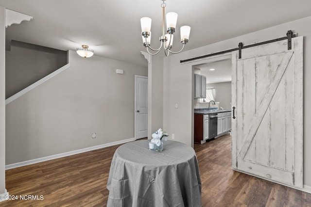 dining room with a chandelier, dark hardwood / wood-style flooring, sink, and a barn door