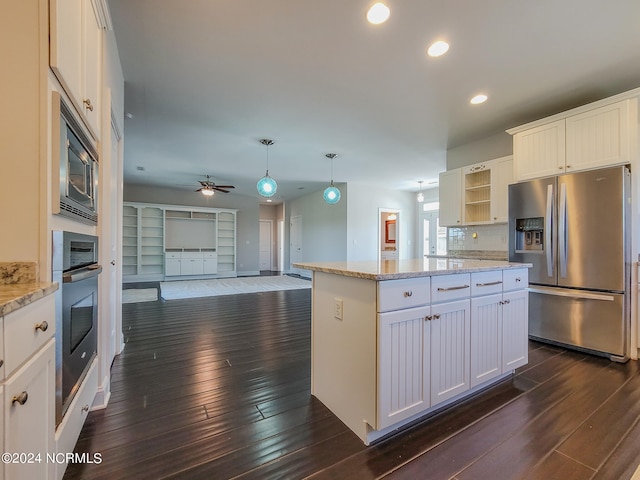 kitchen featuring dark hardwood / wood-style flooring, white cabinets, and stainless steel appliances