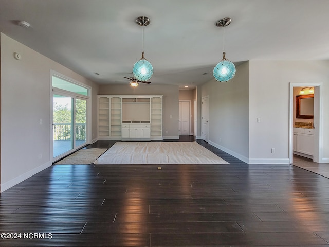 unfurnished living room featuring hardwood / wood-style flooring and ceiling fan