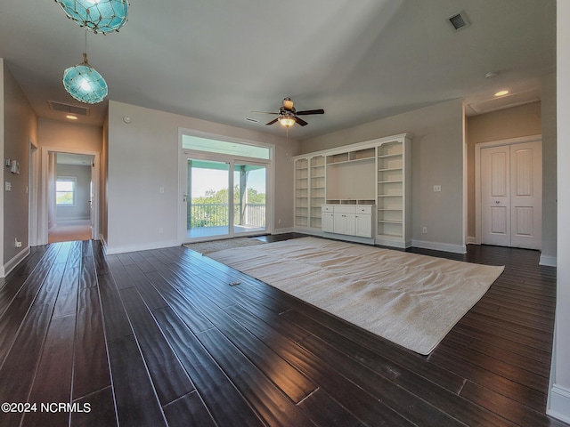 unfurnished living room with dark hardwood / wood-style flooring, a healthy amount of sunlight, and ceiling fan