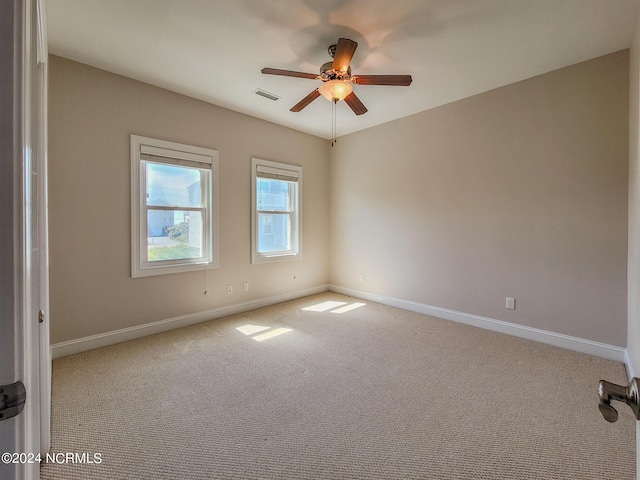 unfurnished room featuring light carpet and ceiling fan