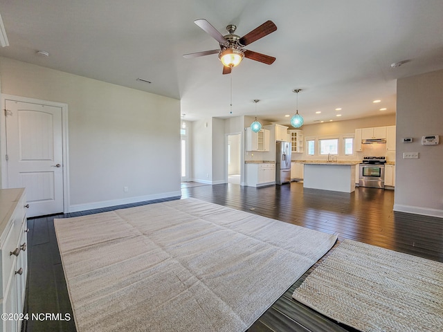 living room featuring hardwood / wood-style floors and ceiling fan