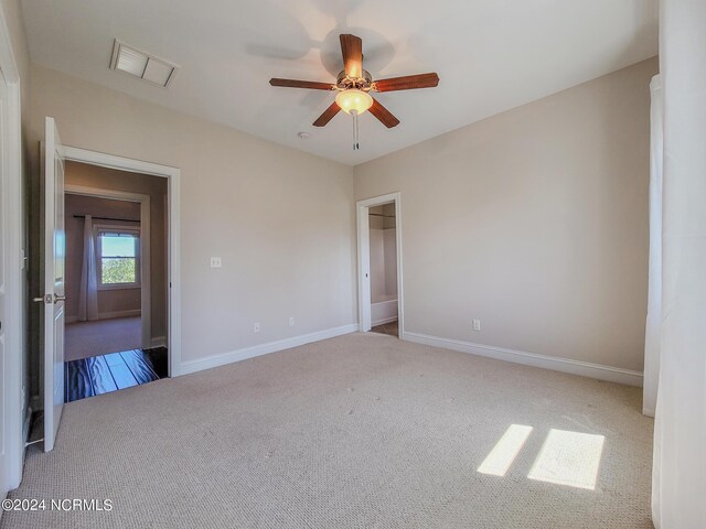 spare room with carpet floors and ceiling fan