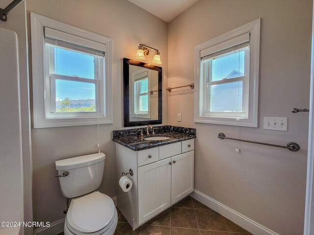 bathroom with vanity, tile patterned floors, and toilet