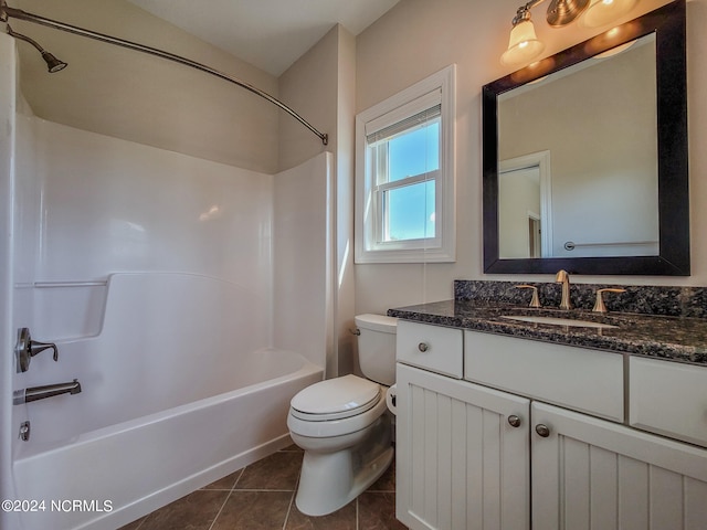 full bathroom featuring tile patterned flooring, bathing tub / shower combination, toilet, and vanity