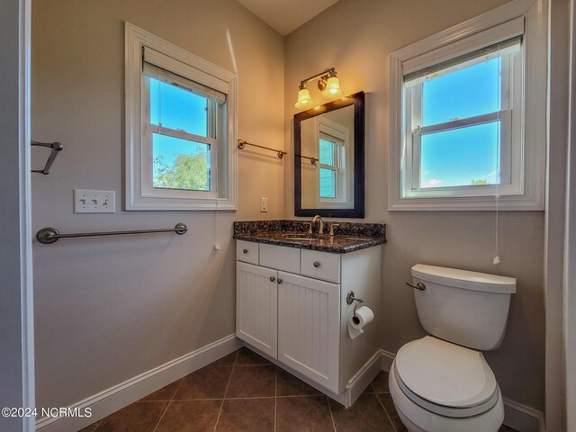 bathroom featuring vanity, toilet, and tile patterned flooring