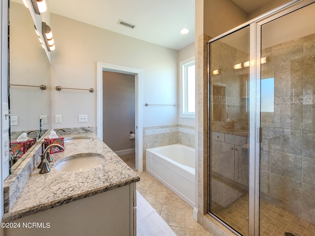 bathroom with separate shower and tub, double sink vanity, and tile patterned flooring