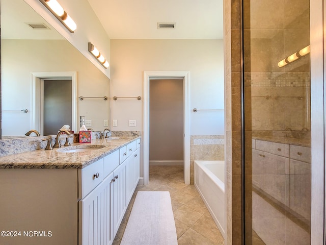 bathroom featuring double vanity, tile patterned flooring, and independent shower and bath