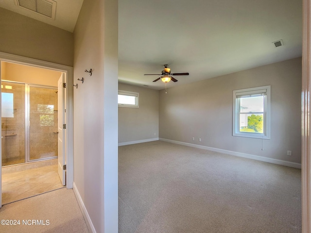 carpeted empty room featuring ceiling fan