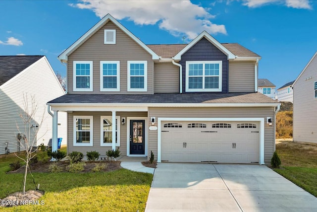 view of front of house with a garage, a front lawn, and covered porch