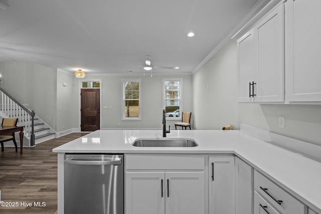 kitchen with a peninsula, ceiling fan, a sink, light countertops, and dishwasher