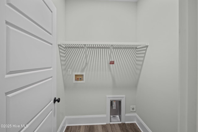 laundry room featuring electric dryer hookup, dark wood-type flooring, washer hookup, baseboards, and laundry area