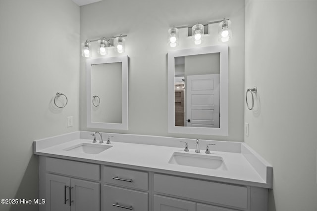 full bathroom with a sink and double vanity