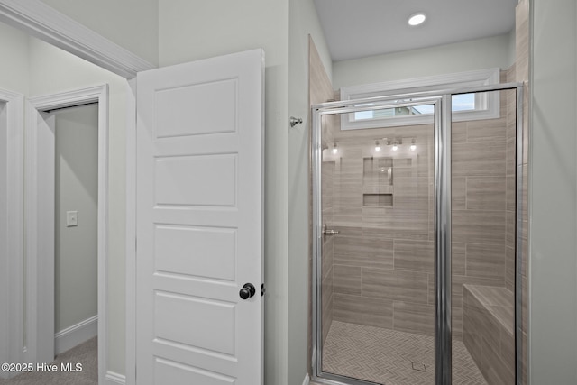 full bathroom with baseboards and a stall shower