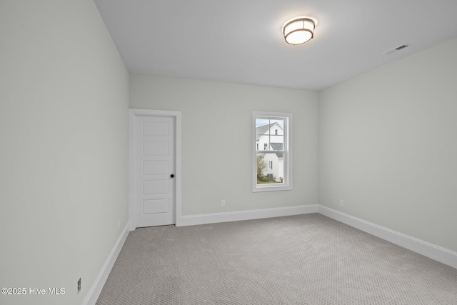 unfurnished room featuring visible vents, carpet, and baseboards