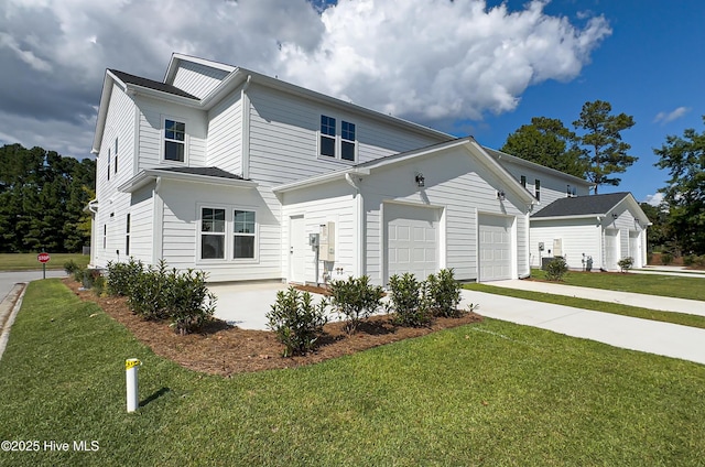 view of front of house featuring a garage, driveway, and a front lawn