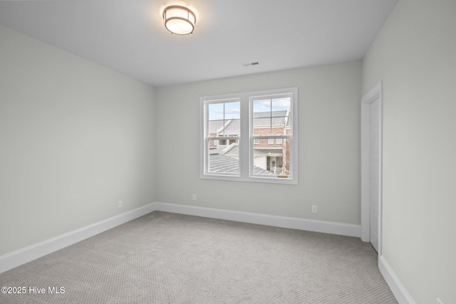 spare room with carpet flooring and baseboards