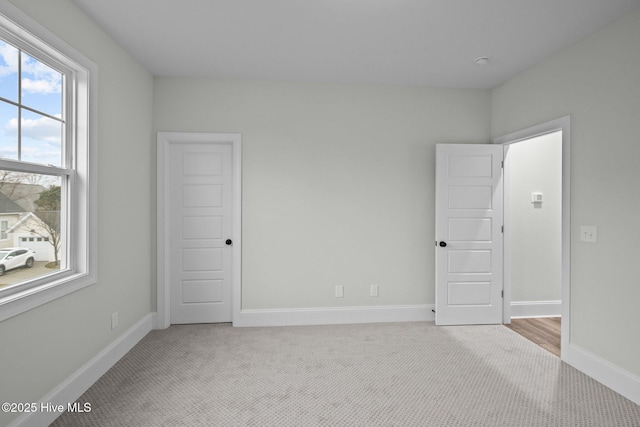 unfurnished bedroom featuring baseboards and carpet