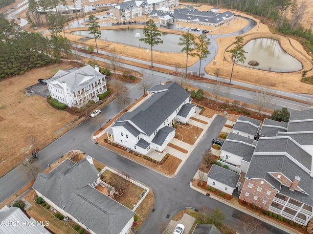 drone / aerial view with a residential view and a water view