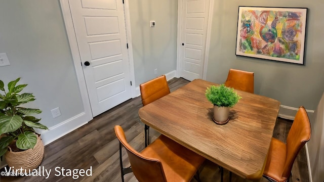 dining area featuring dark wood finished floors and baseboards