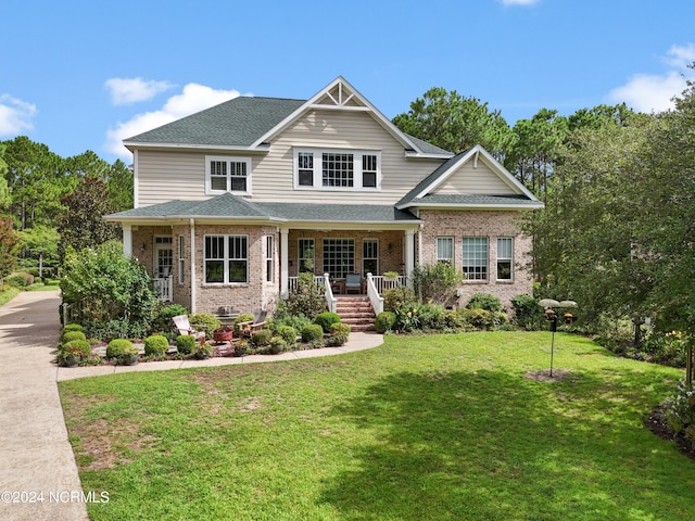 craftsman-style house featuring covered porch and a front yard