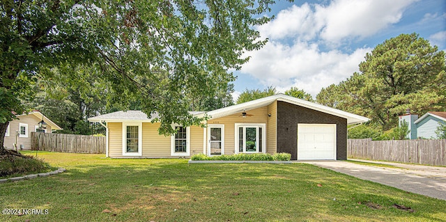 single story home with a garage and a front lawn