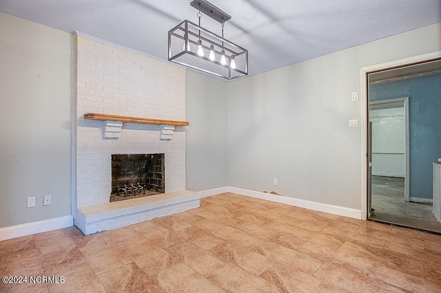 unfurnished living room with brick wall, a fireplace, a textured ceiling, and tile patterned floors