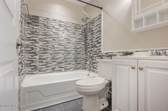 full bathroom featuring vanity, tile patterned floors, tile walls, tiled shower / bath, and toilet