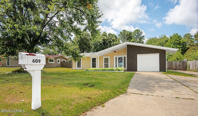 ranch-style home with a garage and a front lawn