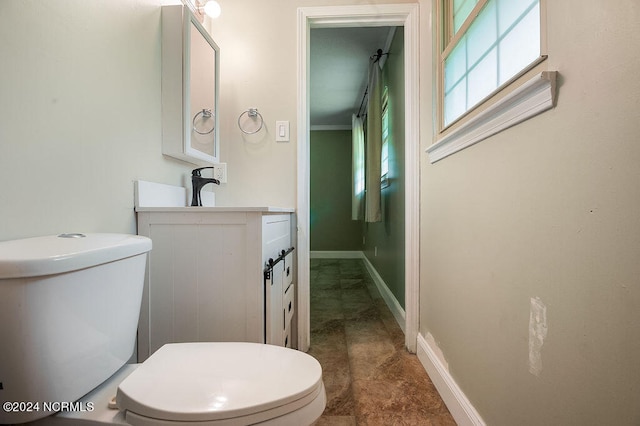 bathroom featuring tile patterned flooring, toilet, and vanity