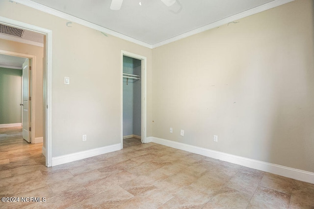 unfurnished bedroom with light tile patterned flooring, a closet, ornamental molding, and ceiling fan