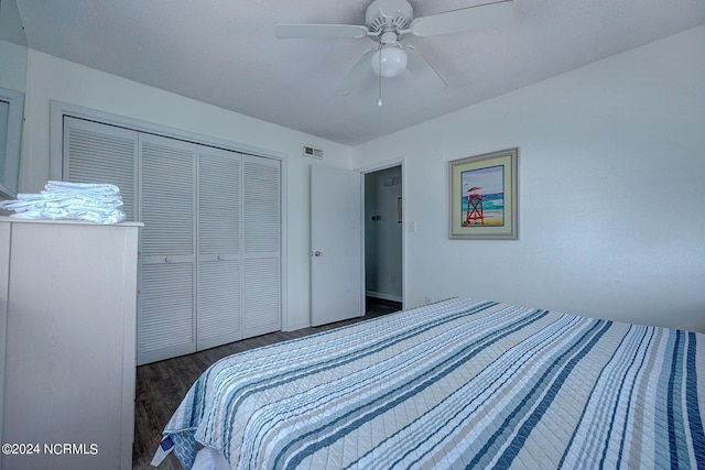 bedroom with dark hardwood / wood-style floors, a closet, and ceiling fan