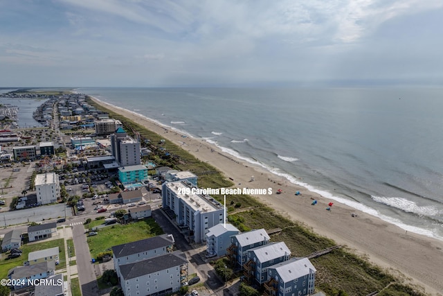 drone / aerial view with a water view and a beach view