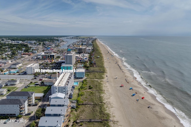 bird's eye view featuring a water view and a beach view